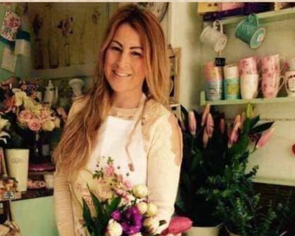 Annie holding a bouquet in her flower shop
