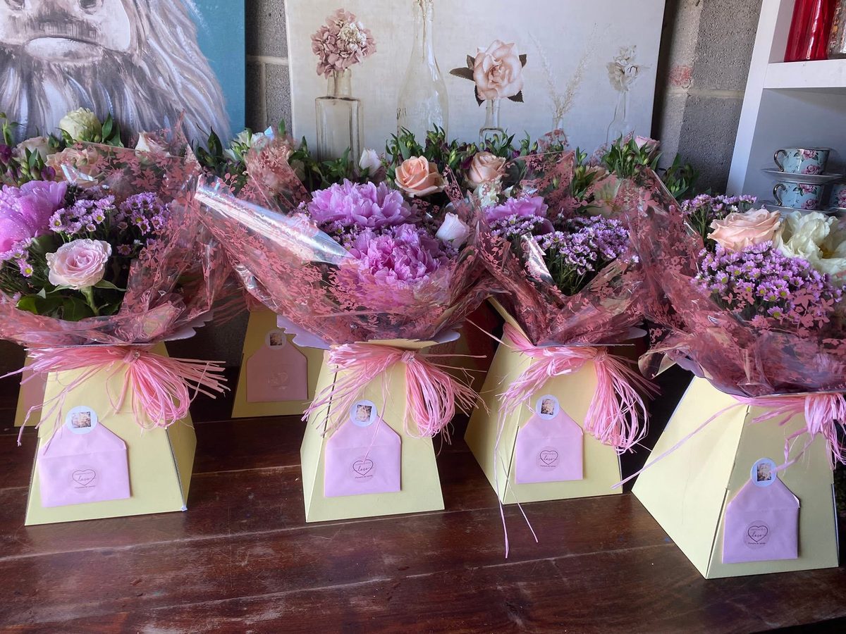 A row of Flowers by Annie gift boxes filled with pastel bouquets