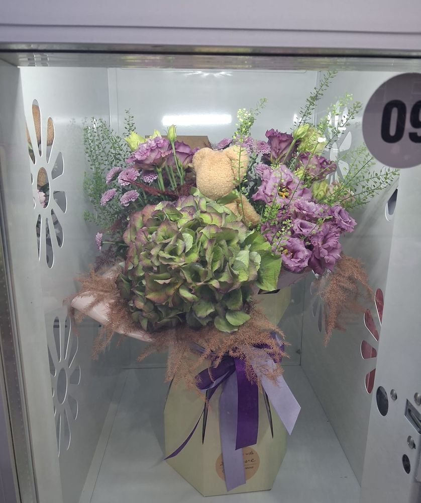 Antique green hydrangea and lilac lisianthus with a little teddy, in a gift box