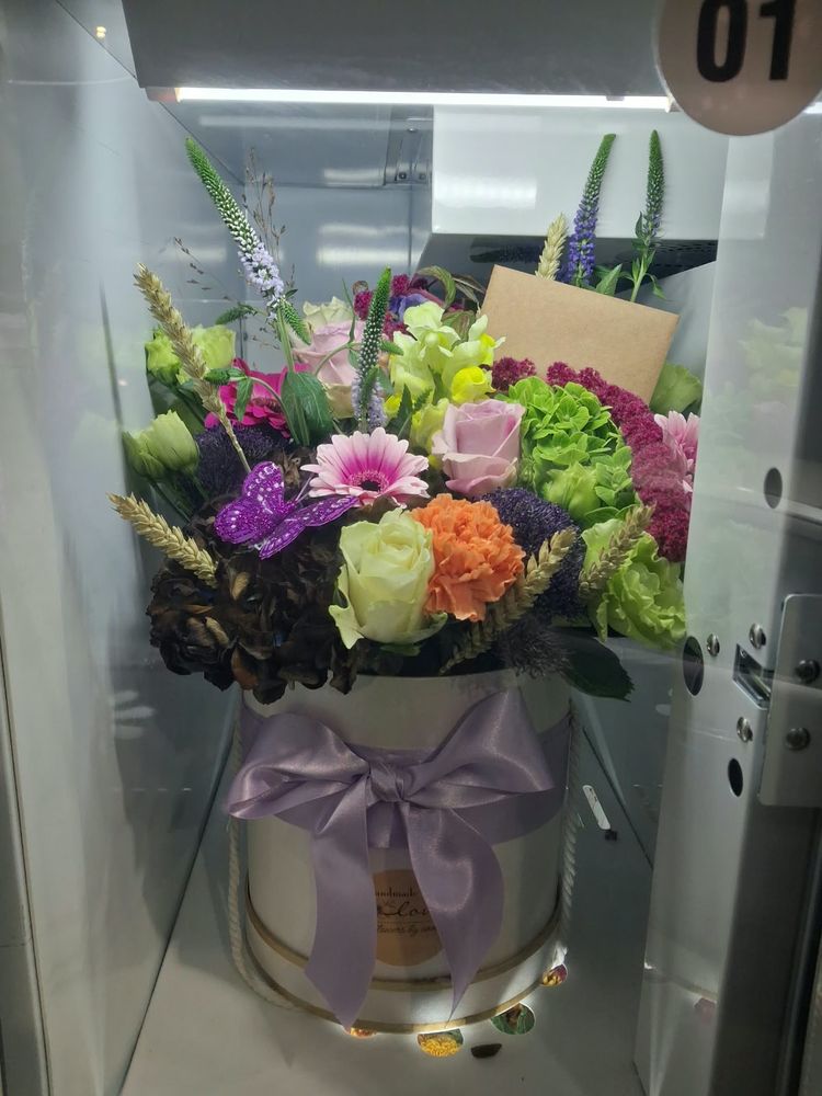 Lilac roses, hydrangea and veronica in an ivory hat box with a lilac bow