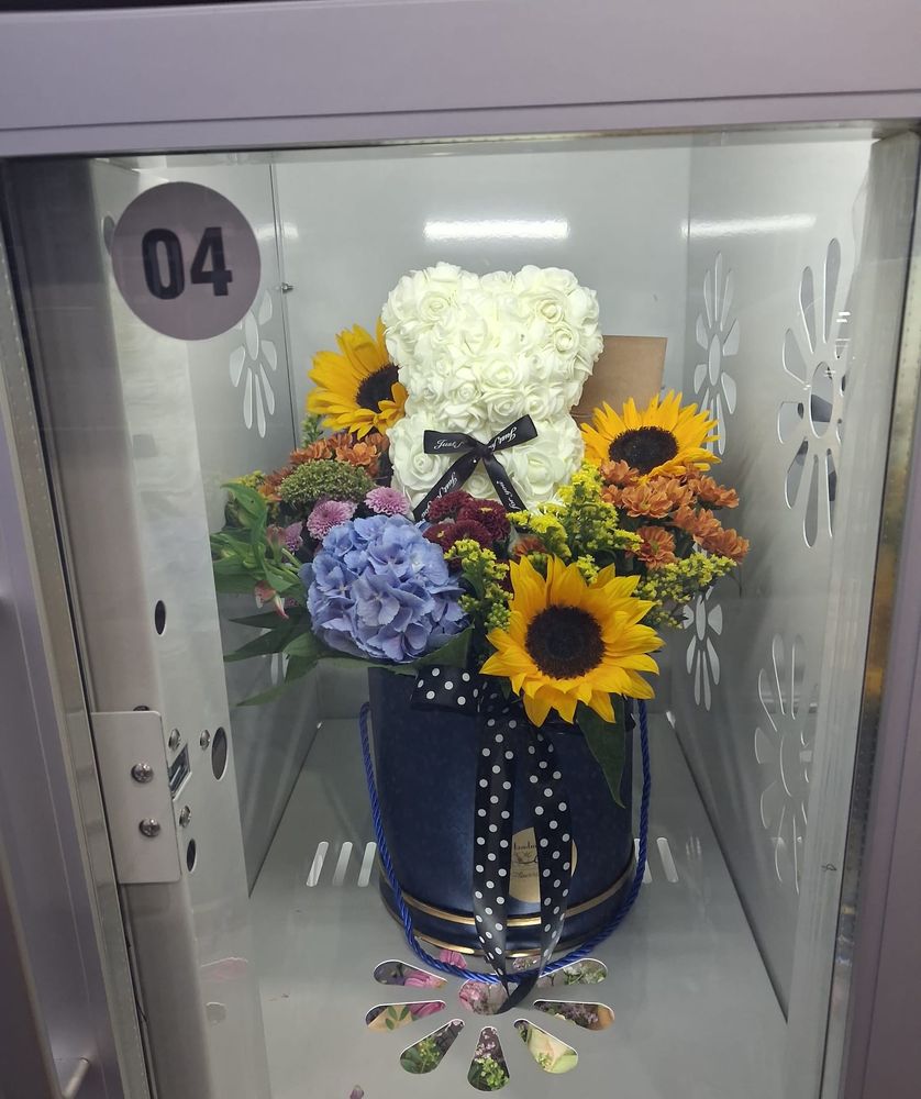 Sunflowers, blue hydrangea and a white rose teddy in a navy velvet hat box
