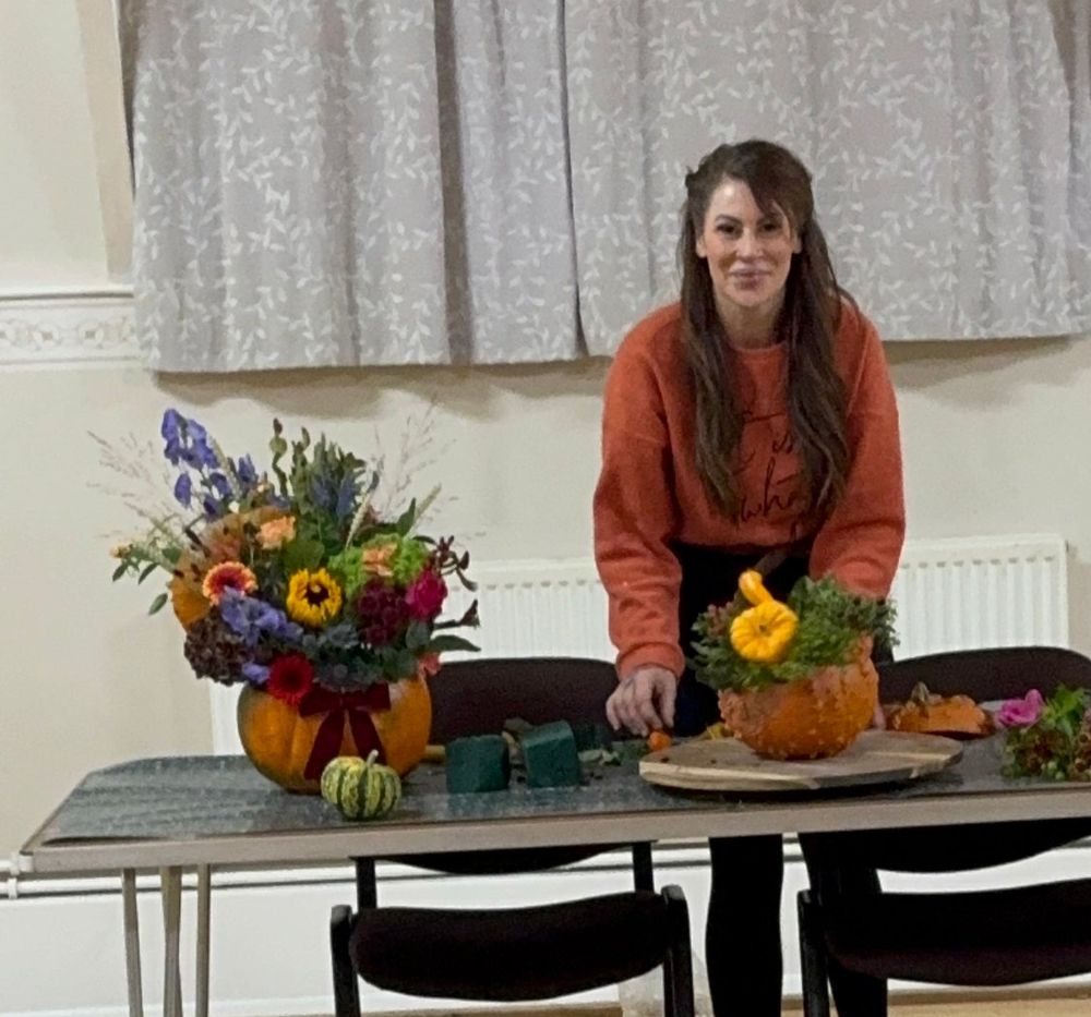 Annie at the front table with finished pumpkin arrangements