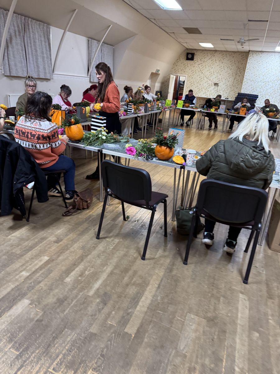 A full room of guests making flower arrangements at a Flowers by Annie workshop